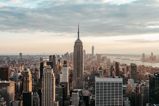 Modern multistage house exteriors against endless sea under cloudy sky in New York City at sunset